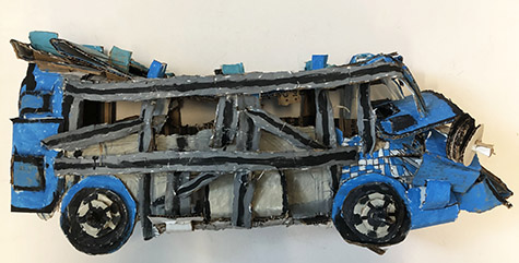 Brent Brown | BRB982 | Bayou the Blue Bus, 2021  | 
	 Cardboard, Mixed Media | 11 x 27 x 10 in. at the Outsider Folk Art Gallery