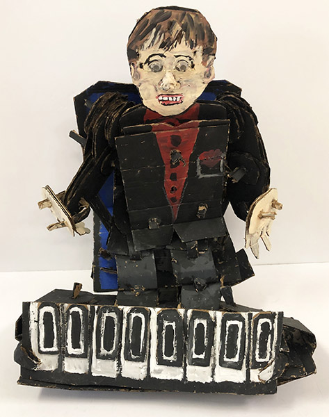 Brent Brown | BRB612 | Elton John Rockin Out, 2019   | 
	 Cardboard, Mixed Media | 20 x 25 x 15 in. at the Outsider Folk Art Gallery