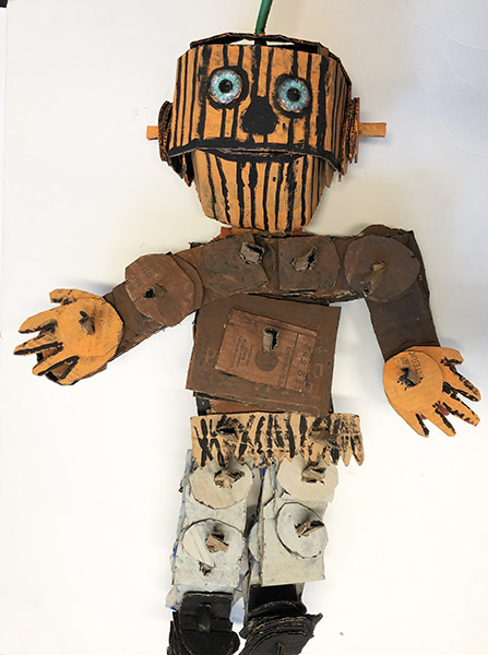 Brent Brown | BRB970 | Pumpkin Man, 2021  | 
	 Cardboard, Mixed Media | 24 x 35 x 10 in. at the Outsider Folk Art Gallery