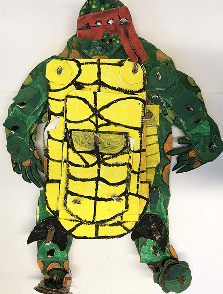 Brent Brown | BRB974 | Turtle in a Yellow Suit, 2021 | Cardboard, Mixed Media | 40 x 40 x 9 in. at the Outsider Folk Art Gallery